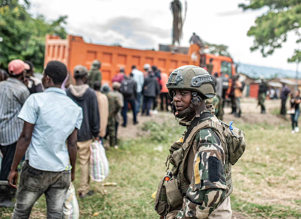An M23 fighter looks on as Wazalendo militants