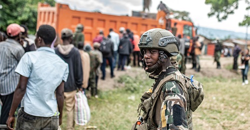 An M23 fighter looks on as Wazalendo militants