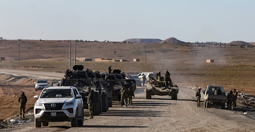 Armoured vehicles of the HTS de facto government make their way to the city of Hasaka in northeast Syria on 20 January 2026