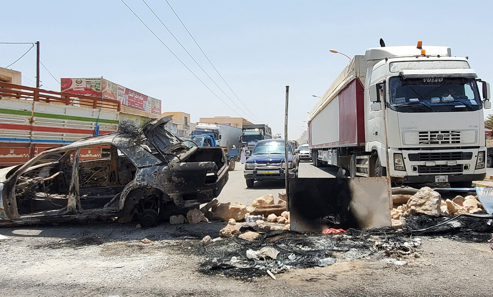 Cars and cargo trucks at a roadblock in the city of Tarim