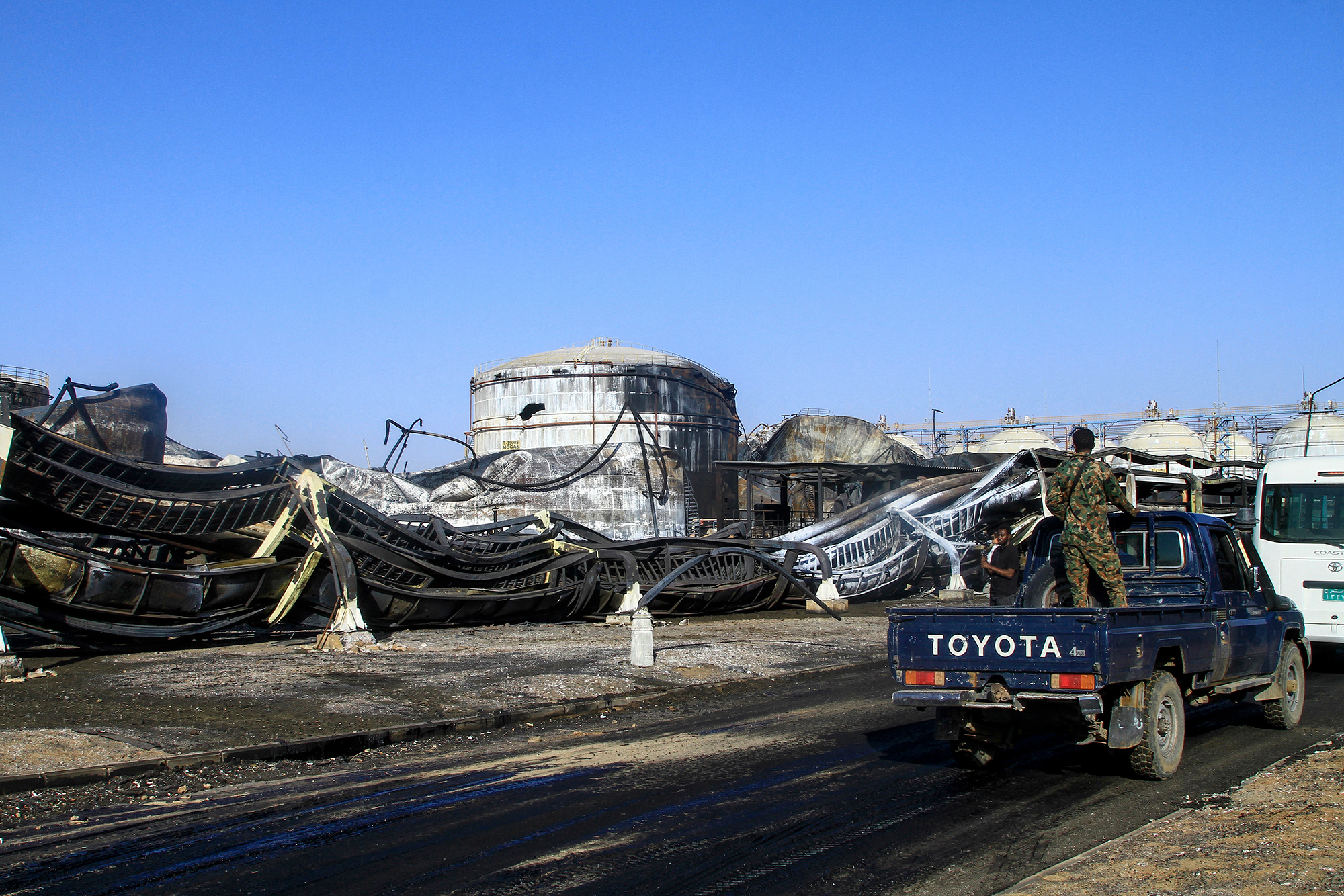 Photograph of a Sudanese army soldier standing on a truck at the heavily damaged Jaili Oil Refinery Sudans largest north of the capital Khartoum on 18 March 2025