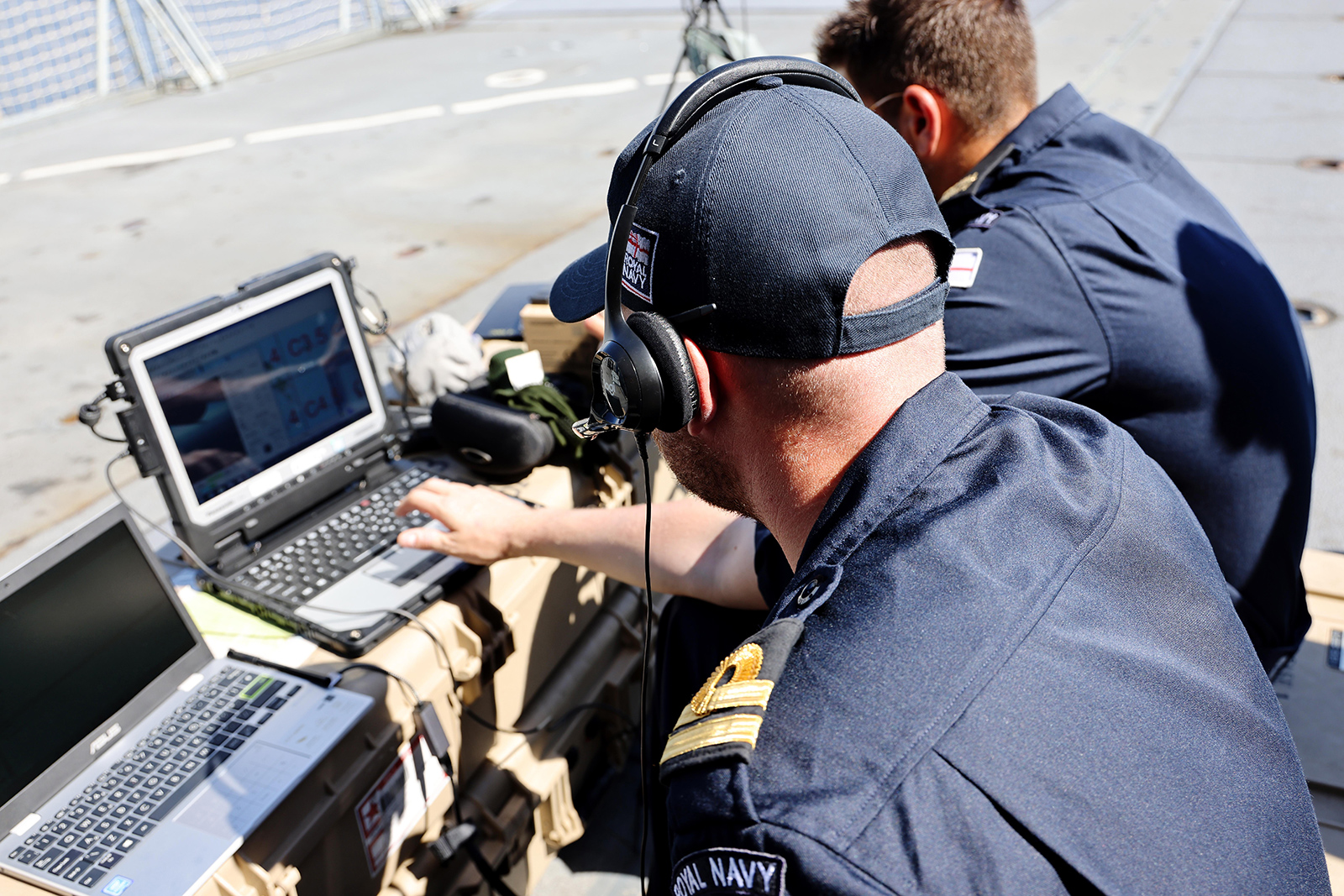 Royal Navy operators prepare a UAV mission onboard a frigate