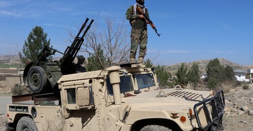A Taliban security personnel stands guard near an anti-aircraft gun while keeping watch for Pakistani airstrikes in the Tere Zayi district of Khost province on 2 March.