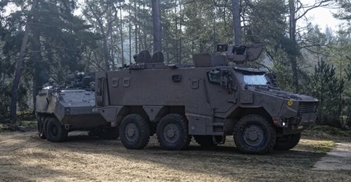 The Belgian army's new Griffon vehicle pictured in front of the Piranha III it is replacing during a military exercise at Camp Bastin in Stockem, southern Belgium.