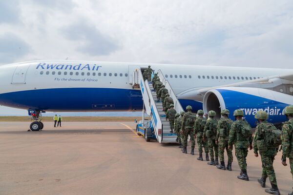 Rwandan troops embark on an airliner destined for Mozambique at Kigali International Airport on 10 July. (Rwandan Ministry of Defence)