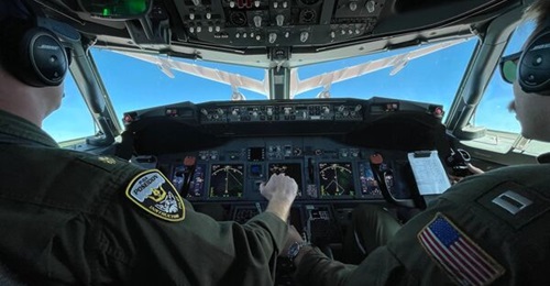 The crew of a US Navy P-8A observes a Royal Australian Air Force KC-30A tanker air-refuelling their aircraft during the fleet certification period of the Royal Australian Navy on 20 March 2022.