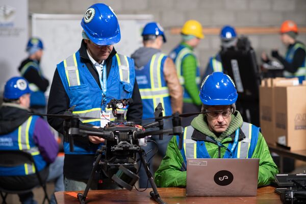 Team CSIRO Data61's DJI Matrice 210 UAV developed by Emesent in an undated image from DARPA's SubT Challenge urban circuit. The aircraft includes a Hovermap payload developed to include a light detection and ranging (LIDAR) sensor that helps the team map the underground environment and locate artefacts. (DARPA)