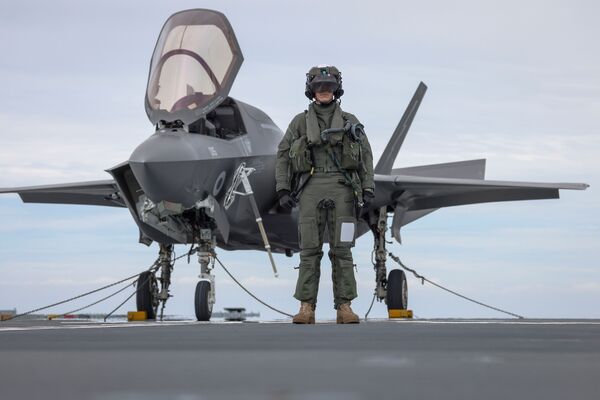 
        F-35B pilot, Squadron Leader Will, stands in front of his aircraft aboard 
        Prince of Wales
        .
       (Crown Copyright)