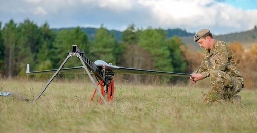 A Belin UAS on its rail launcher with a Slovenian Armed Forces operator.