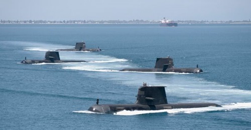 Four of the RAN's six Collins-class submarines in close formation while transiting Cockburn Sound in Western Australia. These conventionally powered boats will now be replaced by a fleet with nuclear propulsion.