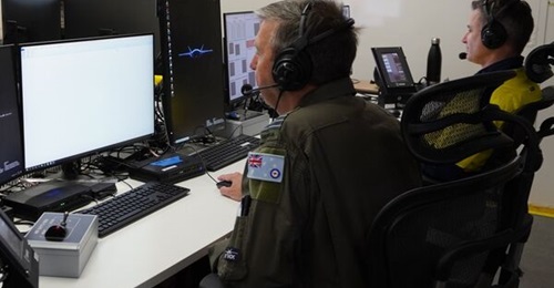 Royal Australian Air Force officer Wing Commander Phil Parsons reviews information associated with the launch and recovery operations of the Boeing MQ-28A Ghost Bat.