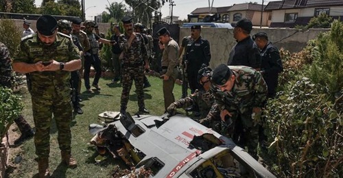Iraqi security forces inspect the debris of the Turkish Aksungur UAV that crashed in Kirkuk 29 August.