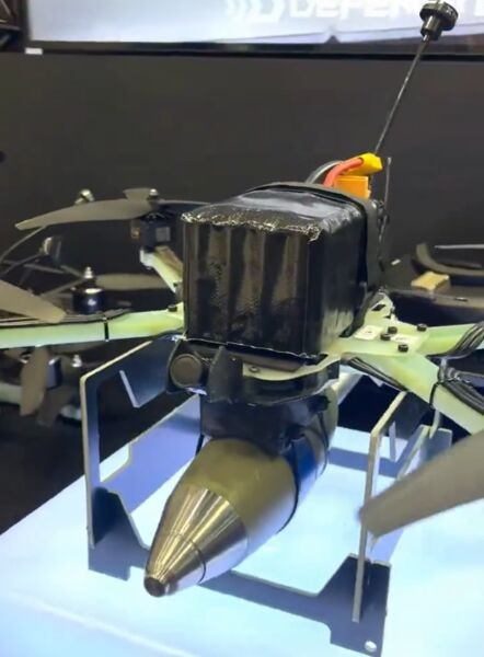 A model of the DefendTex Vengeance FPV UAV, carrying a munition underneath, displayed at the Land Forces 2024 exposition in Melbourne, Australia, in September.