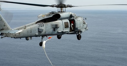 A US Navy Sikorsky MH-60R Seahawk launches an Mk 54 practice torpedo over the waters of Tokyo Bay during an exercise in March 2022.