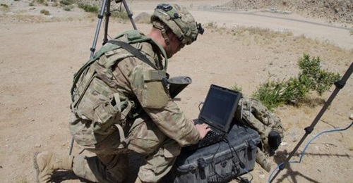 A soldier with the 780th Military Intelligence Brigade sets up equipment during field exercises at the National Training Center at Fort Irwin, California, on 5 May 2017.