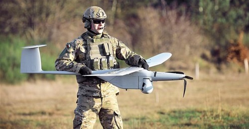 A Polish soldier carrying a FlyEye, which is used by special forces and the army for a range of roles including target location, battery fire control, convoy escort, and border surveillance.