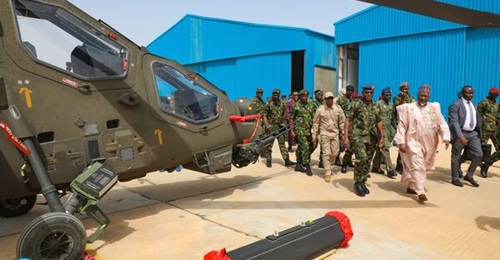 Nigerian Minister of Defence Mohammed Badaru Abubakar inspects a T129 Atak helicopter during a visit to Katsina on 18 November 2024.