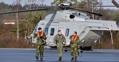 A file photo of Swedish crew members walking from their NH90 helicopter. Sweden has now formally received back the last of 18 such helicopters to be retrofitted to full-operating configuration.