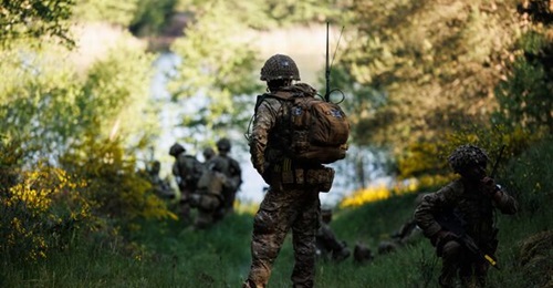 A British soldier taking part in Exercise 'Steadfast Defender' 2024 in Poland carrying a tactical radio using the Bowman C41 communications system.