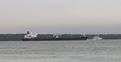 The 
        
        tanker, suspected of cutting undersea cables, is seen on 29 December 2024 anchored off Finland's Kilpilahti oil terminal with a 24 hour escort provided by Finnish Border Guard vessel 
        
        .