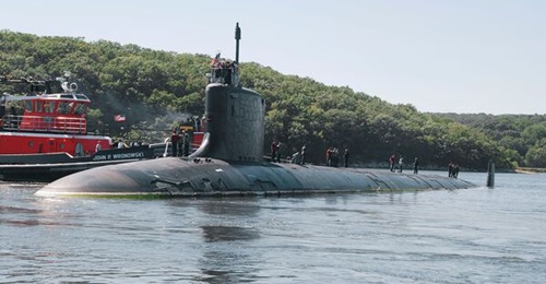 Attack submarine USS 
        
         is shown here going in for maintenance in Maine in 2021. About a third of the attack submarine force is now in maintenance, the CBO reported.