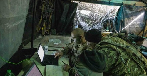 A US Army all-source intelligence technician, assigned to 2nd Battalion, 34th Armored Regiment, 1st Armored Brigade Combat Team, assists the battalion intelligence officer during the 'Allied Spirit X' exercise in Germany.