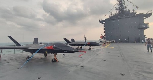 Two of the new unmanned subscale naval versions of the Qaher F-313 manned fighter prototype seen aboard Iran's new 
        
        drone carrier on 6 February.