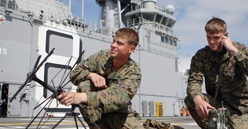 Marines with 1st Tank Battalion perform radio checks on a Harris 117 radio in preparation for exercises aboard USS 
        
        .