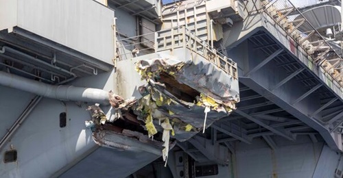 Repairs have been completed on collision damage, shown here, to aircraft carrier USS 
        
        .