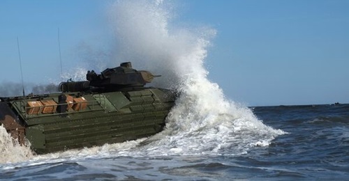 An AAV7 amphibious assault vehicle with the 24th Marine Expeditionary Unit enters the water at Camp Lejeune on 3 October 2018 to embark on USS 
        
         (LPD 21) in preparation for Exercise 'Trident Juncture 2018'. The USMC is plannin...