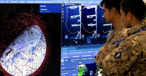 British Army soldiers look at equipment and software on display while deployed to Denmark as part of the Joint Expeditionary Force on Exercise 'Joint Protector' in November 2022.