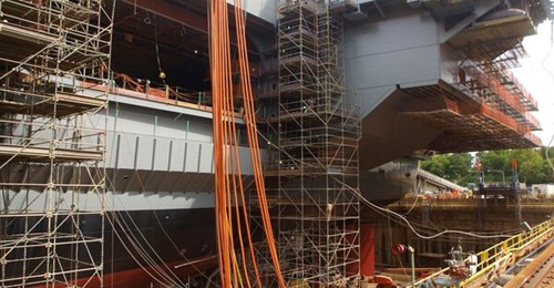 Aircraft carrier 
        
        is shown here under construction. US Navy and congressional changes have delayed delivery schedule and navy Secretary John Phelan wants to curtail such schedule-altering changes.