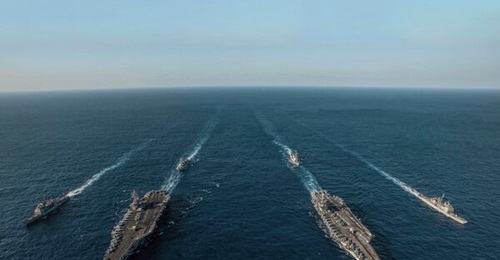 Ships with the Ronald Reagan Carrier Strike Group and John C Stennis Carrier Strike Group transit the Philippine Sea during dual-carrier operations.