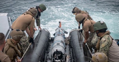 US sailors retrieve a Mk 18 Mod 2 unmanned underwater vehicle during a transit through the Northern Mariana Islands.