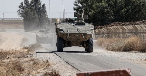 Eitan APCs with the Nahal Brigade drive along the Gaza-Sinai border near Rafah on 29 May 2024.