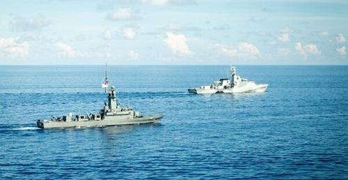 HMS 
        
        (background) operating with RSS 
        
        at Exercise 'Bersama Shield' 2025.