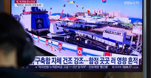A TV news broadcast at Seoul Railway Station shows North Korea's new destroyer
        
         at its launch ceremony.