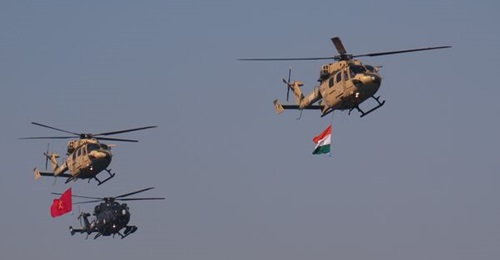Two Army HAL Dhruv helicopters fly in formation with an ALH Mk IV Rudra helicopter during an Indian Army parade on 9 January 2023.