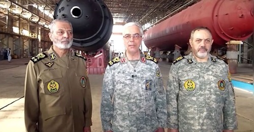 A still taken from Iranian television news shows Major General Mohammad Bagheri (centre) standing in front of what appear to be two submarine hulls during a visit to Shahid Darvishi Industries.