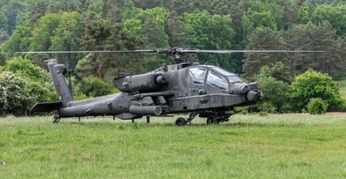 A US Army AH-64E lands during exercises in Germany during 2023. A prominent army general is questioning the helicopter's combat effectiveness based on the performance of attack helicopters in the Ukraine war.
