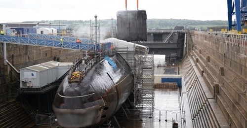The fin of the ex-
        
        - the first decommissioned Royal Navy submarine undergoing dismantling - is lowered after being cut away from the main body of the boat at Babcock's dockyard in Rosyth, Scotland.