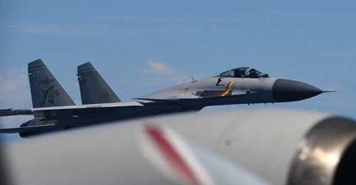 A PLAN Shenyang J-15 carrier-borne fighter aircraft flies next to a Japan Lockheed P-3C maritime patrol aircraft on 8 June 2025.