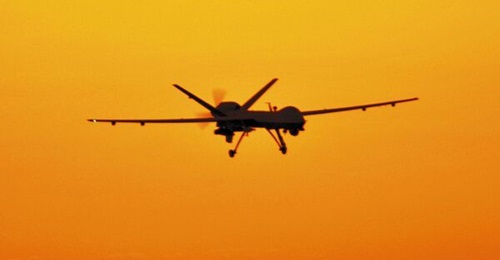 The USAF MQ-9 Reaper unmanned aerial vehicle landing at sunset.