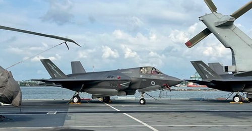 An F-35B seen here on the flight deck of HMS 
        
        as it docked in Singapore. One of the carrier's F-35B is presently stranded in India after a weather emergency.