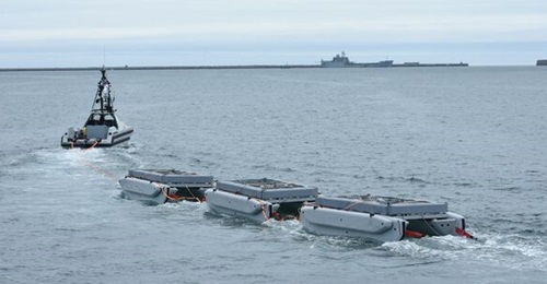 The ARCIMS USV platform RNMB 
        
        operating with an MHC Sweep package - including three coil auxiliary boats - in Portland harbour.