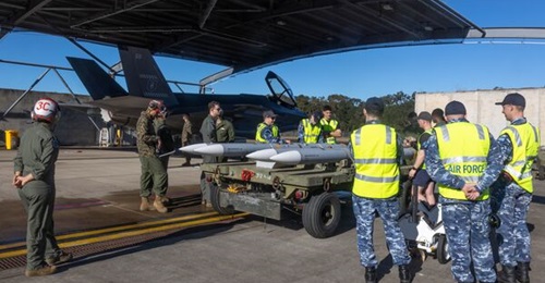 US Marine Corps and RAAF personnel inspect AIM-120D AMRAAMs prior to loading onto a RAAF F-35A Lightning II at RAAF Base Darwin following exercises in Australia in 2023.