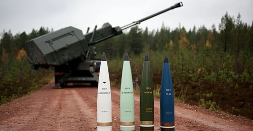 Artillery shells from Nammo's 155 mm family (HE-ER second from right) seen in front of an Archer SPH.