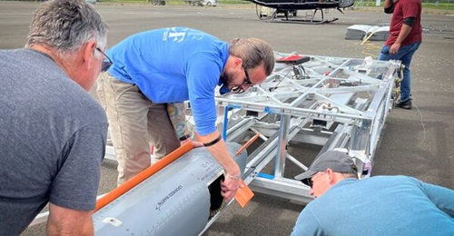 Lockheed Martin's CMMT-D is inserted into a three-cell Rapid Dragon mount prior to flight-testing.
