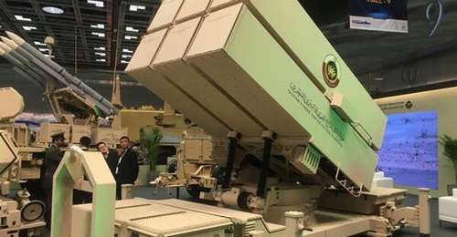 A Qatari static NASAMS launcher displayed at the DIMDEX show in Doha in March 2024 with a mobile launcher armed with four AMRAAMs in the background.