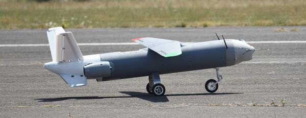 A prototype of MGI's SkyShark OWE, displayed in the UK in July 2025 and equipped with Argive's A300 single-stage micro turbojet.